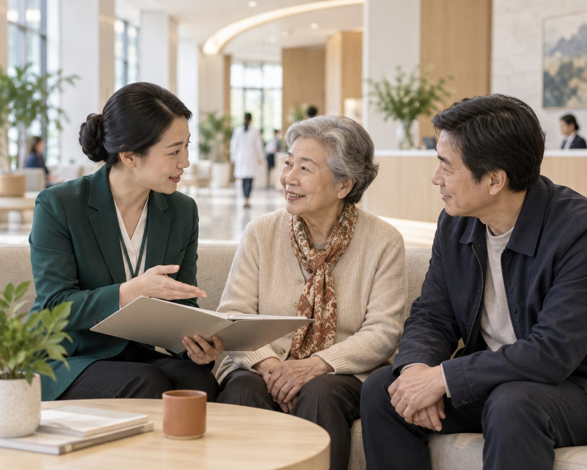 A coordinator with an older mother and her son in a hospital lobby
