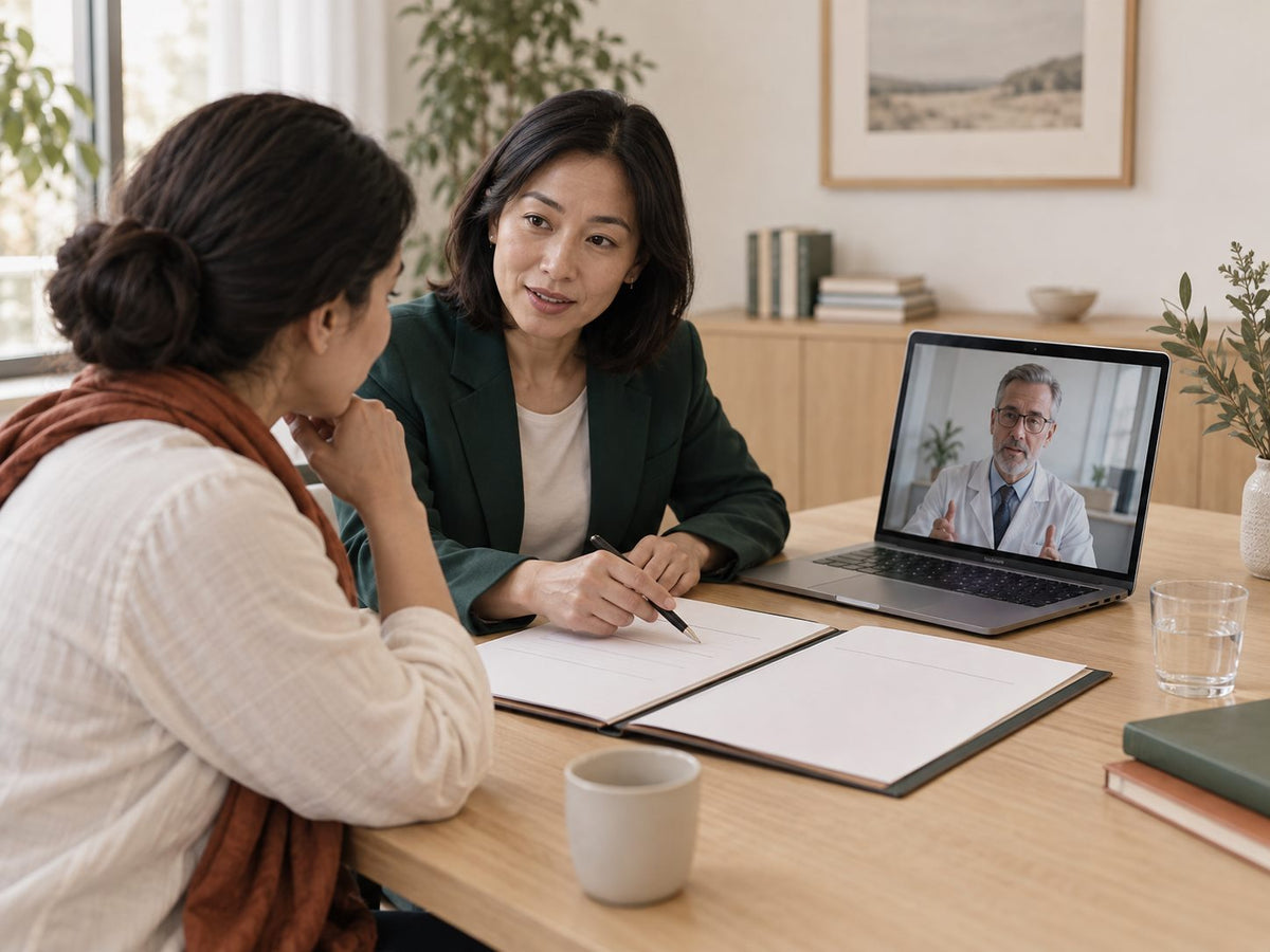 A coordinator with a patient during a video consultation with a specialist