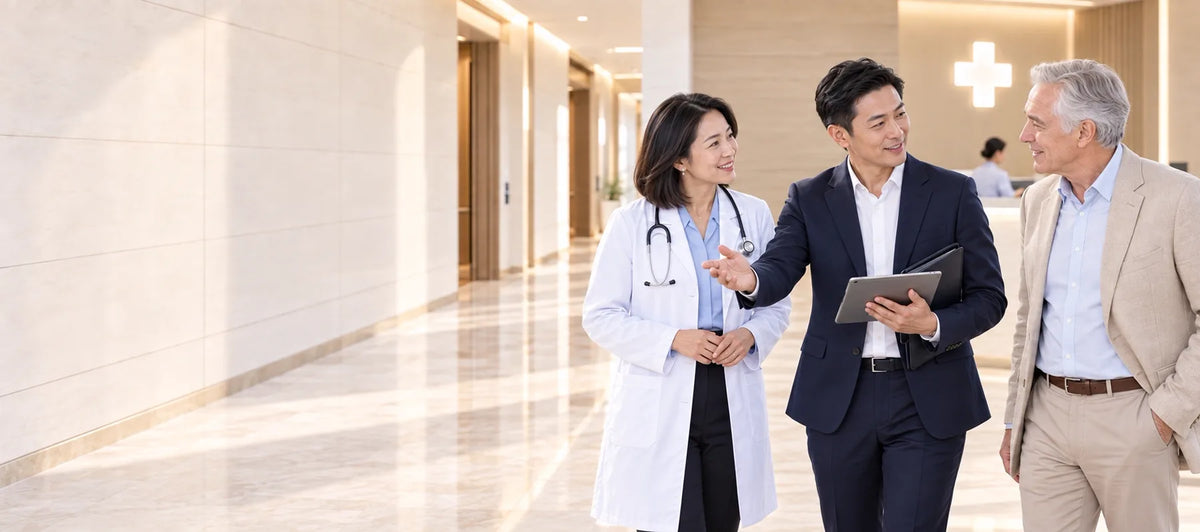 A coordinator with a doctor and a family in a hospital lobby